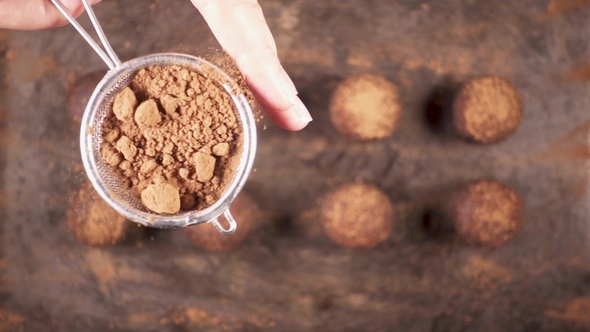 Sprinkle Candy Cocoa Powder From a Small Spoon-sieve