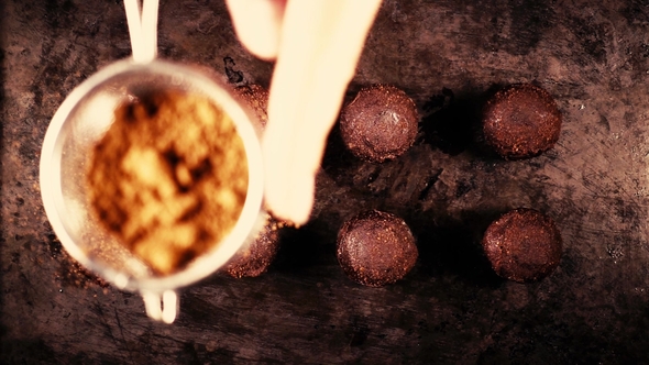 Sprinkle Candy Cocoa Powder From a Small Spoon-sieve