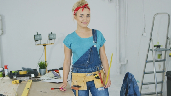 Female Carpenter Standing at Workbench alt
