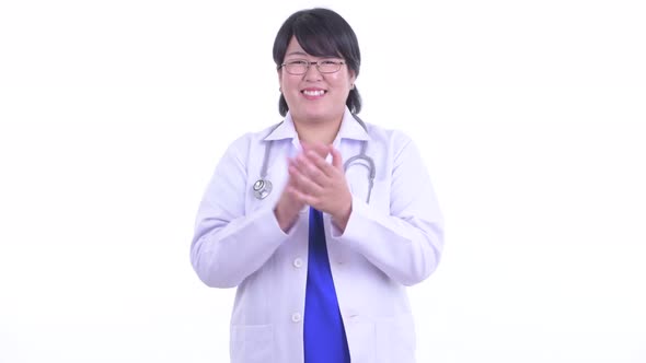 Happy Overweight Asian Woman Doctor Clapping Hands alt
