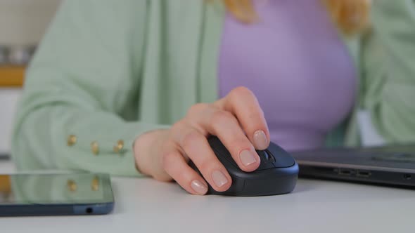 Freelancer woman using wireless mouse and laptop computer for distant work online in 4k video alt