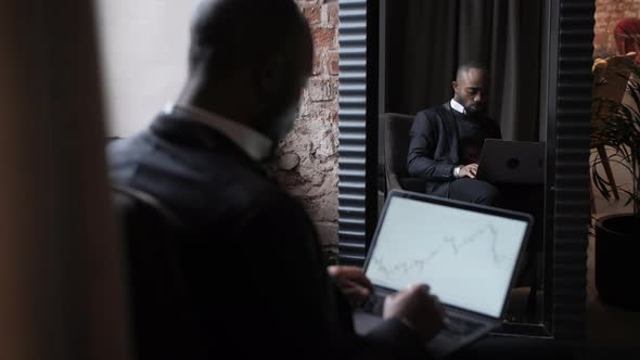 Black Businessman Using Laptop for Analyzing Data Stock Market Stock Exchange Trading Online
