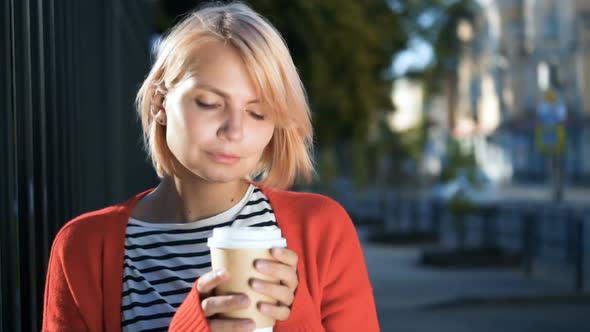 Beautiful Blonde Woman Relaxing Outside Coffee Shop alt