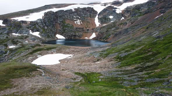 Group of hikers exploring the scenic Crater Lake near Smithers, British Columbia, in Canada. Aerail alt