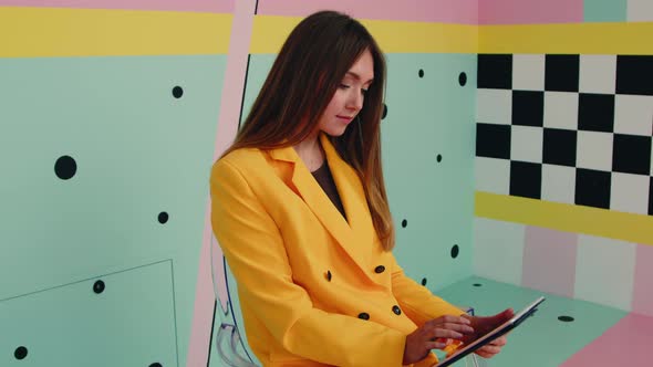 Woman In Yellow Suit Enjoys Online Interaction