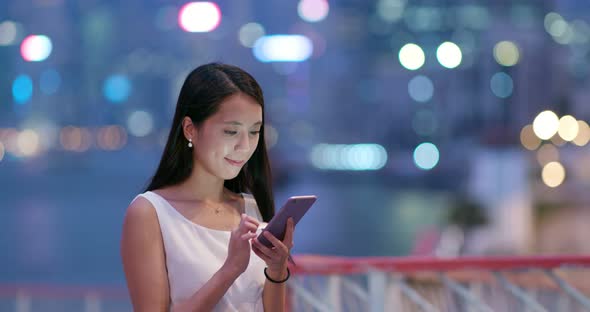 Woman use of mobile phone at night alt