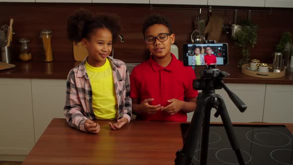 Positive Adorable Preadolescent Black Kids Recording Video for Vlog Indoors, Stock Footage