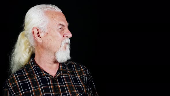 The Man Looks To The Left And Smiles alt