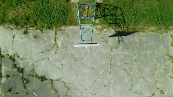 Old Basketball Backboard. Made From Boards. Peeling Paint And A Battered Basket. alt