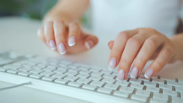 Female Hands Typing on a Computer Keyboard alt