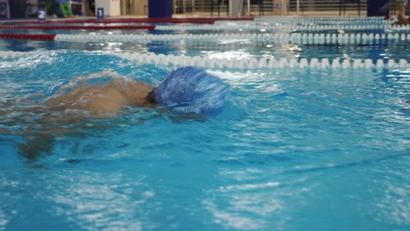 Male Swimmer Performing Butterfly Stroke