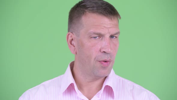 Face of Serious Mature Macho Businessman Nodding Head No alt