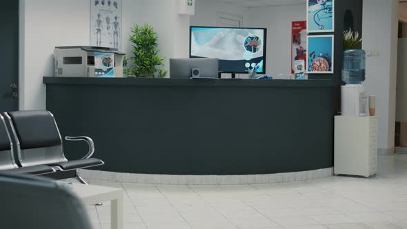 No People in Waiting Area with Reception Counter Desk at Medical Clinic alt