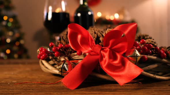 Grapevine wreath with red ribbon and pine cone alt