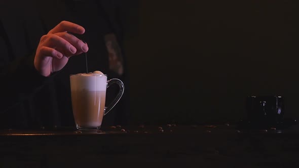 A Bartender Man Gives Ready-Made Coffee To A Client. Barista Pushes Coffee To the Client