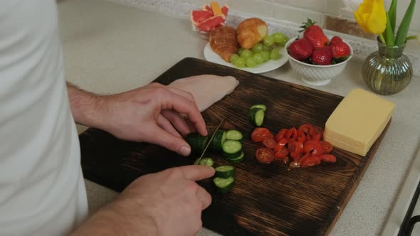 Close Up of an Young Man That Prepares Food in the Kitchen To His Lovely Wife alt
