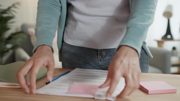 Close up shot of businesswoman work from home hand holding financial report paperwork document alt