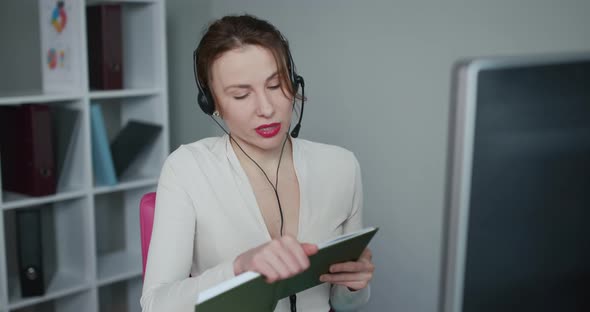 Woman in Headphones Speaking by Webcam at Webinar Training Look at Laptop Make Notes alt