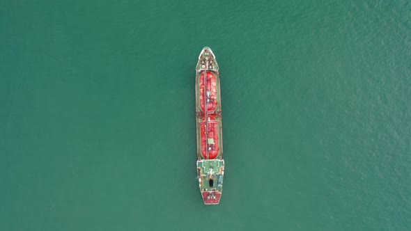 Drone flying with Refinery industry cargo ship. Fuel for transport.