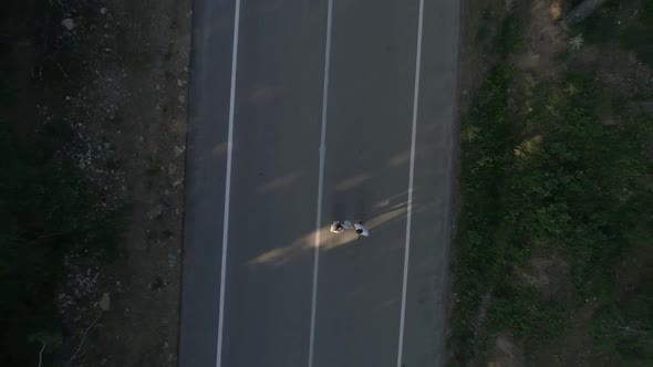 Couple Walking On Forest Road Aerial View