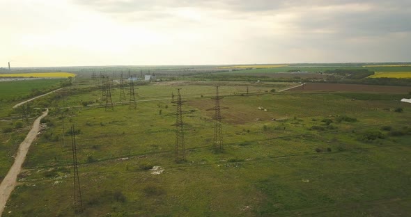 Flying Over Large Power Poles In The Countryside