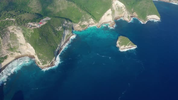 Aerial View of Beautiful Cliffs Overgrown with Green on Kelingking Beach alt