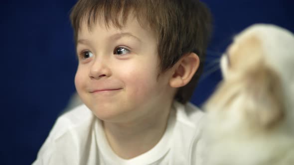 Portrait of a Happy Boy Playing with a Dog alt