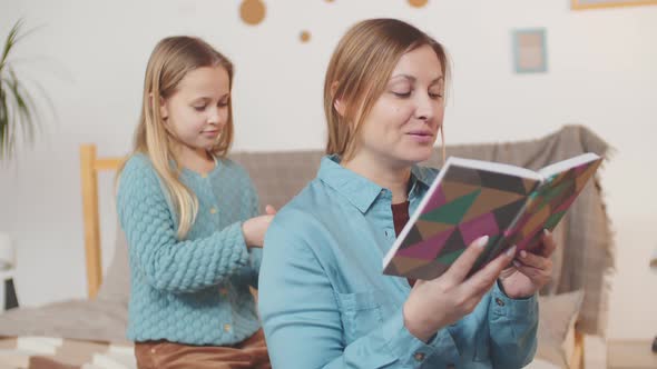 Girl Weaving Braid to Her Mum alt