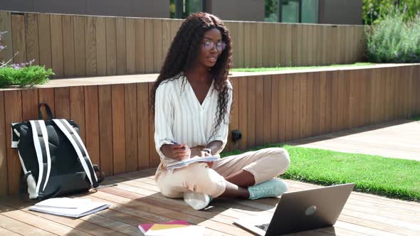 Young Happy Black Woman Student Learning Virtual Online Seminar Class Outdoor alt