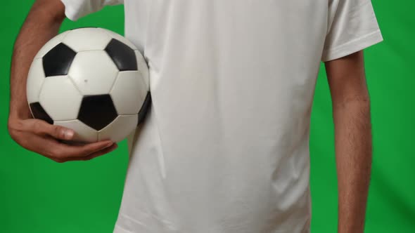 Unrecognizable Middle Eastern Young Man with Soccer Ball on Green Screen Mockup alt
