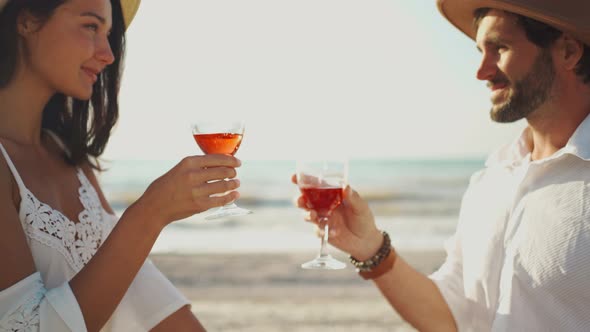 Close Up Hands Cheering Glassesof Wine on Sea Background alt