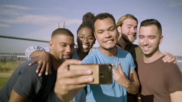 Smiling Friends Gesturing While Taking Selfie with Smartphone alt