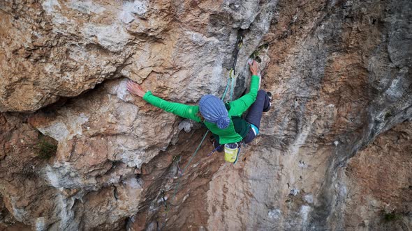 Slow Motion Aerial View Strong Moman Rock Climber Climbs on Overhanging Crag By Hard Challenging alt