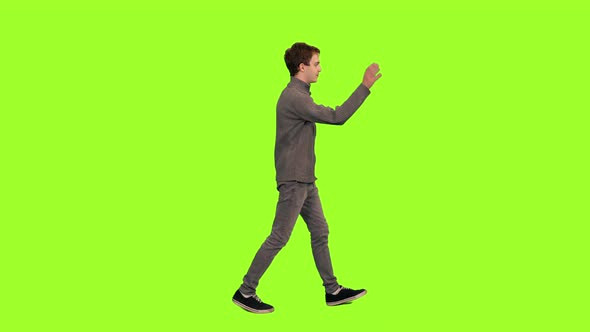 Young Friendly Man Waving Hand Hi While Walking