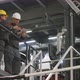 Factory Workers In Helmets Discussing Work - VideoHive Item for Sale
