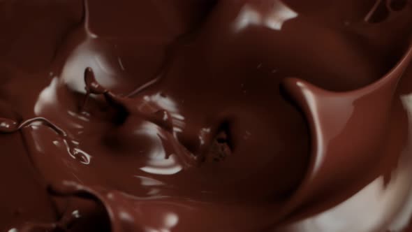 Super Slow Motion Shot of Raw Chocolate Chunks Falling Into Melted Chocolate at 1000Fps alt