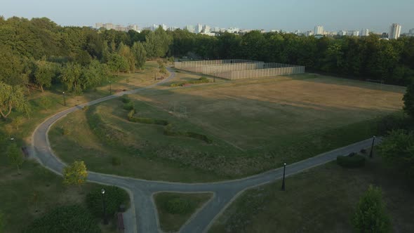 Ground Sports Grounds In The City Park. With A Mesh Fence. City Park At Dawn. Aerial Photography.