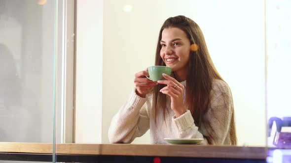 Portrait of Satisfied Woman Drinking Tea at Cafe
