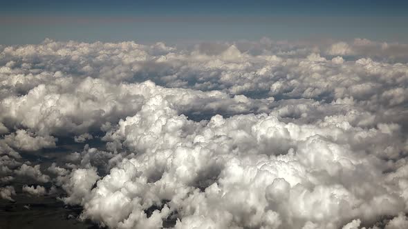 Airplane View of Partly Cloudy and Cumulus Clouds Condensed in Clusters in Humid Warm Air alt