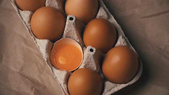 The Broken Egg Lies in the Container Among the Whole Eggs alt