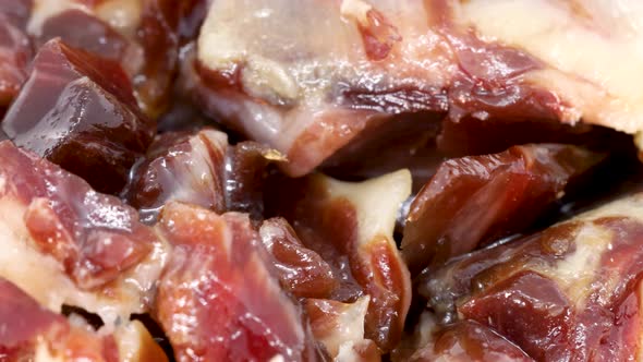 Macro shot of small serrano ham slices rotating. Extreme close up view in 4k. alt