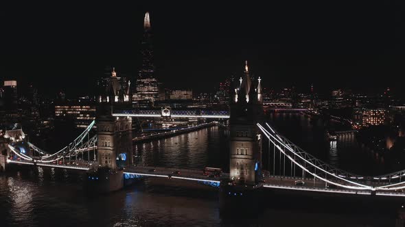 Aerial View to the Illuminated Tower Bridge and Skyline of London at Night UK alt