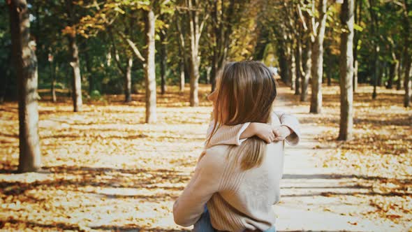 Young Blonde Mother is Smiling Holding Little Daughter in Arms and Circling with Her During Walk in alt
