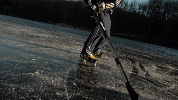 MOSCOW RUSSIA 10 DECEMBER 2019 Hockey Player on Frozen Lake Make Ice Sparkles on High Speed Braking alt