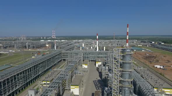 An Aerial View of an Oil Refining Complex Against Bright Blue Sky alt