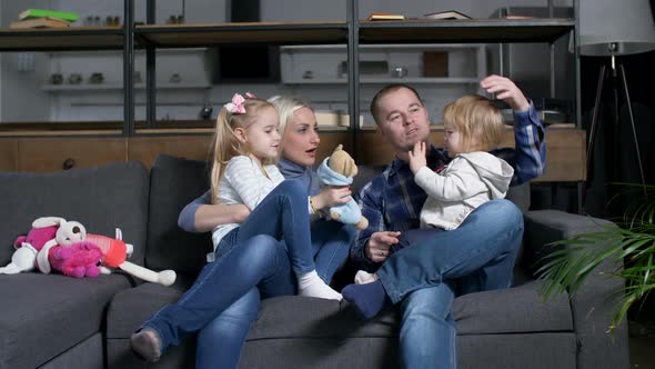 Happy Family Communicating with Toddler Girl at Home alt