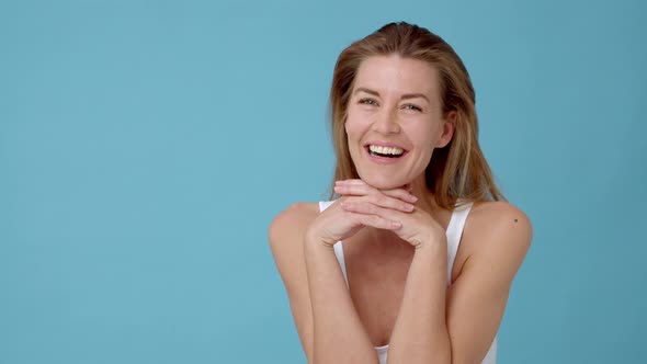 Flawless Model Laughing while Showing Off Her Face with Her Hands