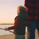 Little Boy is Holding Hand of Father and Admiring Beautiful Landscape with River and Sunset - VideoHive Item for Sale