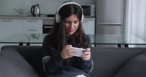 Young Woman Playing Video Games on Her Smartphone and Gets Angry As She Lose the Game alt