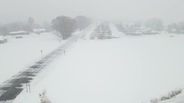 Snow filled sky in a valley in Wisconsin. Mobile home park tucked into the trees.